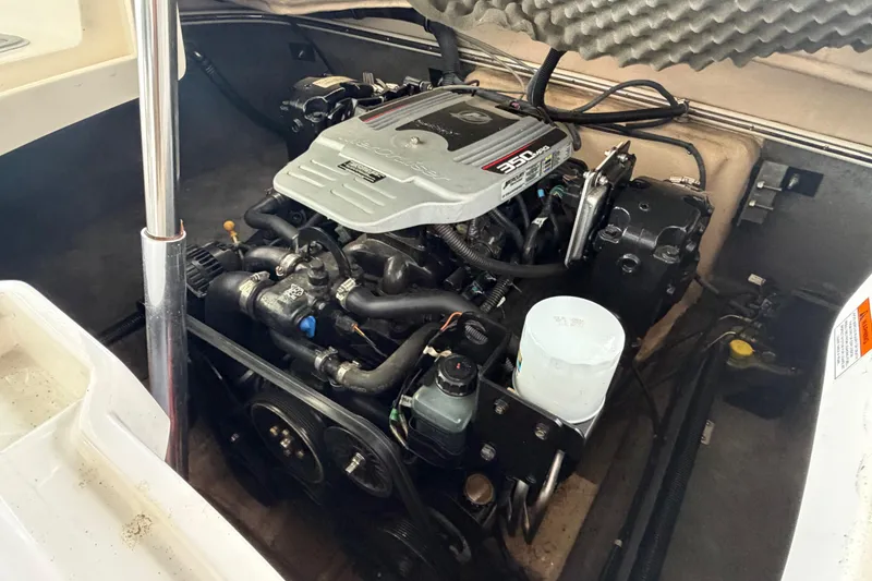 Slide: The Image of Engine compartment of a 2010 Bryant 255 boat, featuring a 350 MAG engine. - 54