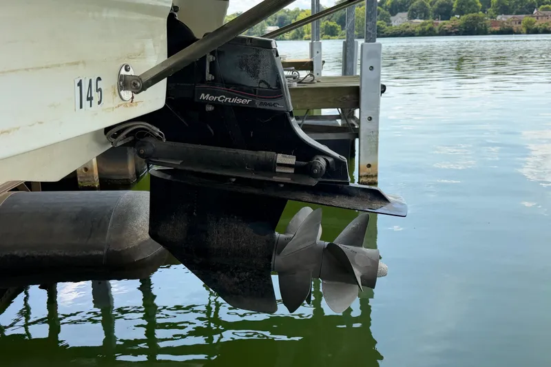 Slide: The Image of Boat propeller and MerCruiser outdrive on a 2010 Bryant 255 near a dock. - 56