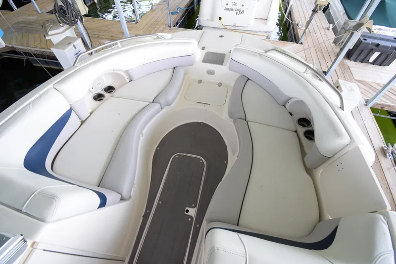 Slide: The Image of The image shows the spacious cockpit of a Bryant 255 boat with white upholstery. - 8