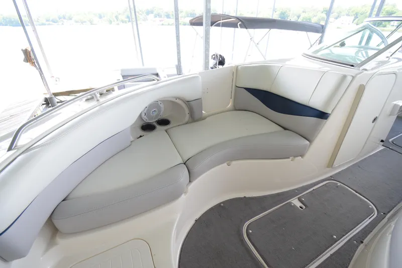 Slide: The Image of Interior view of a Bryant 255 boat with curved seating and carpeted floor. - 9