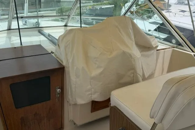 Slide: The Image of 1980 Chris-Craft 381 Catalina boat interior with covered helm and seating area. - 11