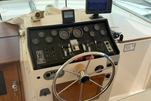 Slide: The Image of 1980 Chris-Craft 381 Catalina helm with gauges, steering wheel, and navigation equipment. - 12