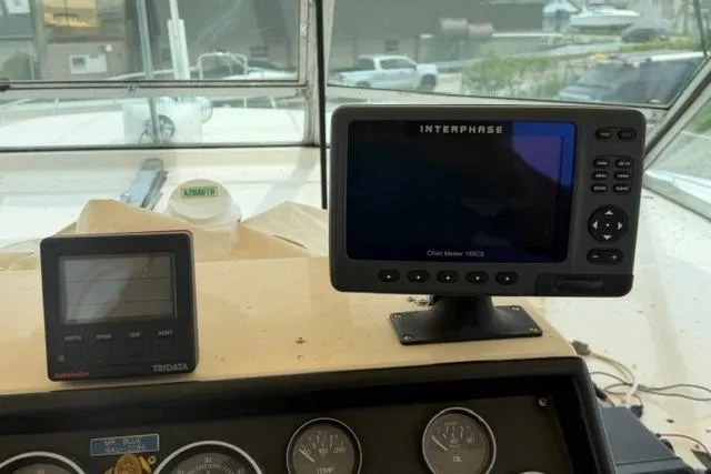 Slide: The Image of Dashboard of 1980 Chris-Craft 381 Catalina with navigation and monitoring equipment. - 13