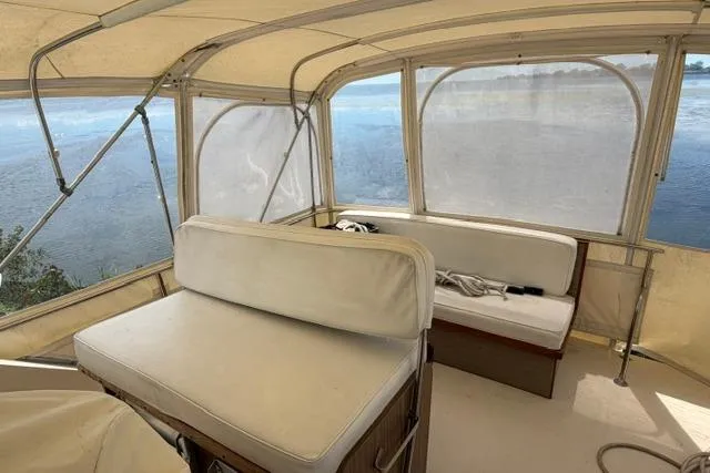 Slide: The Image of 1980 Chris-Craft 381 Catalina boat interior with white seating and panoramic windows. - 16