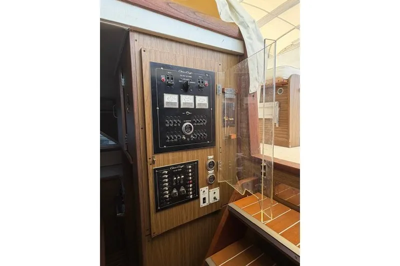 Slide: The Image of Electrical control panel inside a 1980 Chris-Craft 381 Catalina boat, featuring switches and gauges. - 17
