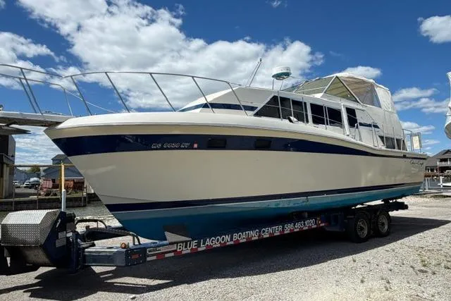 Slide: The Image of 1980 Chris-Craft 381 Catalina boat on trailer under blue sky. - 2