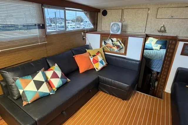 Slide: The Image of Interior of 1980 Chris-Craft 381 Catalina yacht with modern seating and colorful pillows. - 20