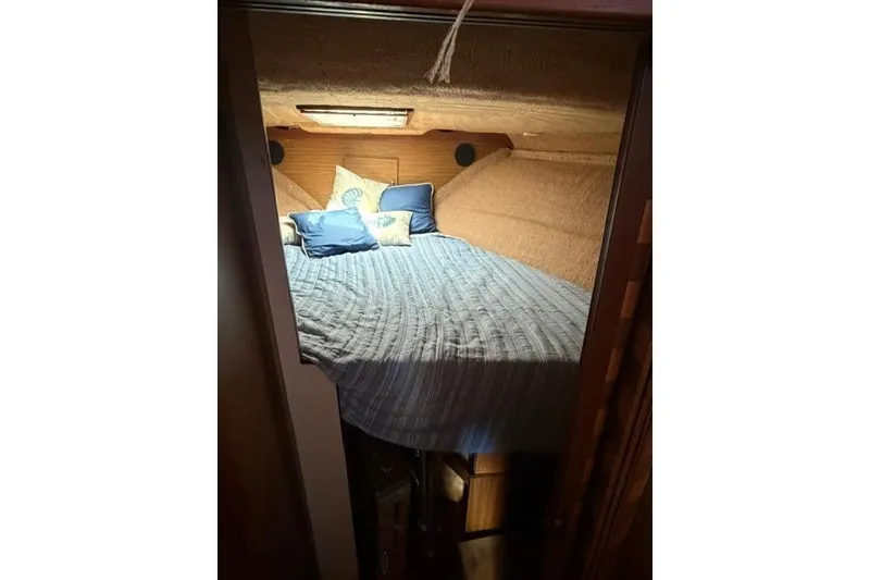 Slide: The Image of Cozy cabin interior of 1980 Chris-Craft 381 Catalina with bed and pillows. - 22