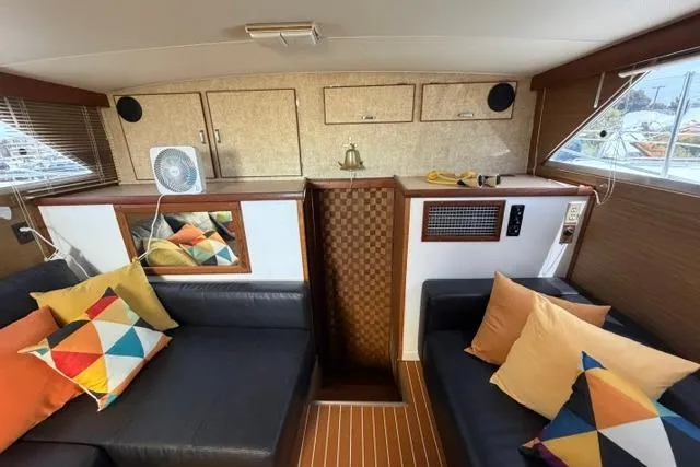 Slide: The Image of 1980 Chris-Craft 381 Catalina interior with colorful cushions and wood paneling. - 23