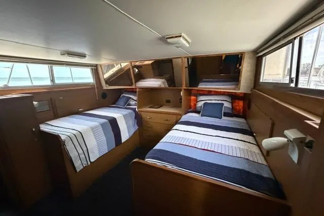 Slide: The Image of Interior of 1980 Chris-Craft 381 Catalina with twin beds and nautical decor. - 24