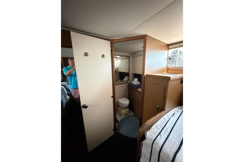Slide: The Image of Interior of 1980 Chris-Craft 381 Catalina yacht showing bathroom and cabin area. - 25
