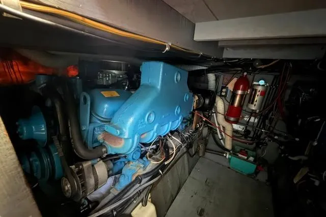 Slide: The Image of Engine room of 1980 Chris-Craft 381 Catalina, showcasing mechanical components and wiring. - 28