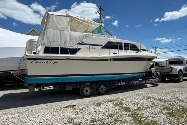 Slide: The Image of 1980 Chris-Craft 381 Catalina boat on trailer under clear blue sky. - 3