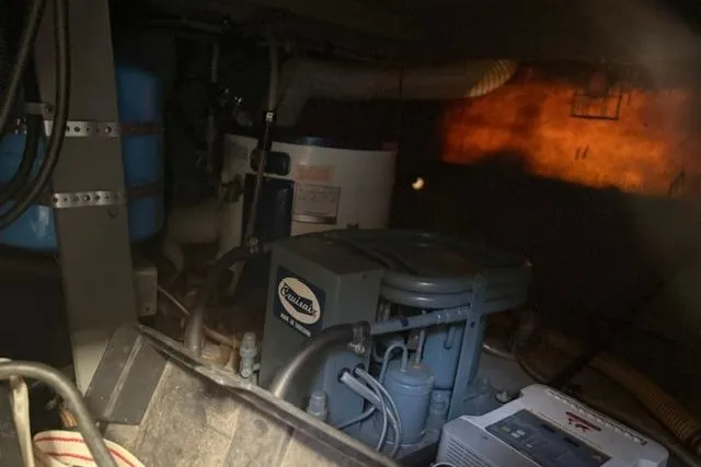 Slide: The Image of Engine room of 1980 Chris-Craft 381 Catalina with visible machinery and equipment. - 31