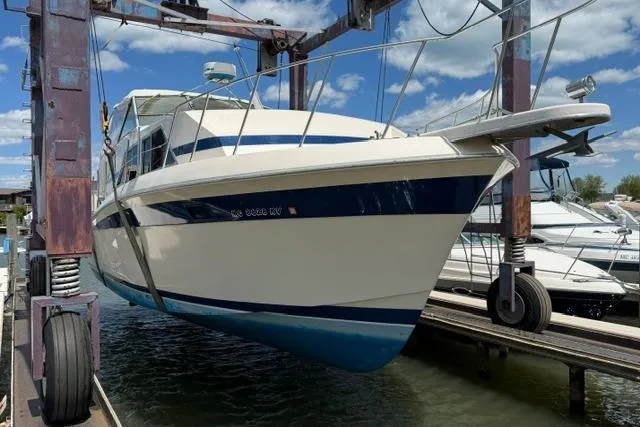 Slide: The Image of 1980 Chris-Craft 381 Catalina yacht in dry dock, showcasing classic design and blue accents. - 5