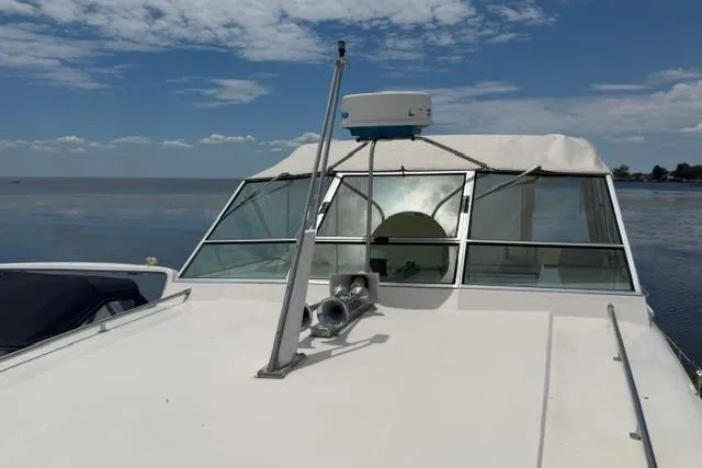 Slide: The Image of 1980 Chris-Craft 381 Catalina boat on calm water under a clear sky. - 8