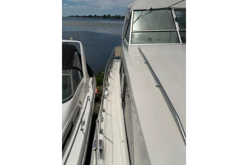 Slide: The Image of 1980 Chris-Craft 381 Catalina yacht docked by the water. - 9