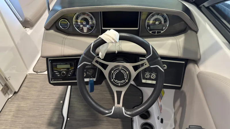 Slide: The Image of The image shows the helm of a 2022 Four Winns HD5 boat with modern instruments. - 21