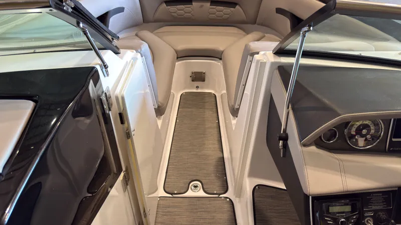 Slide: The Image of The image shows the cockpit of a 2022 Four Winns HD5 boat with gray flooring. - 29