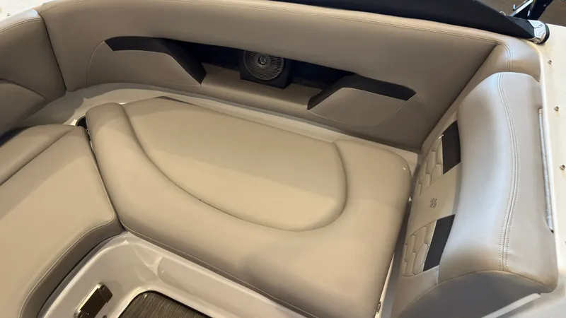 Slide: The Image of The image shows beige upholstery in the rear seating area of a 2022 Four Winns HD5 boat. - 34