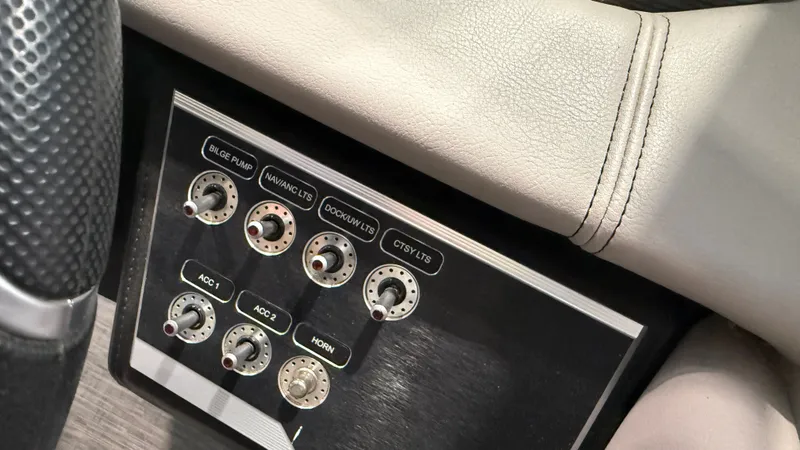 Slide: The Image of Close-up of a control panel with multiple switches and a leather cushion. - 27