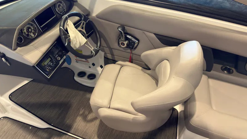 Slide: The Image of The image shows the cockpit of a 2022 Four Winns HD5 boat with a beige captain's chair. - 19