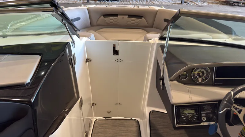 Slide: The Image of The image shows the cockpit of a 2022 Four Winns HD5 boat with modern instruments. - 30