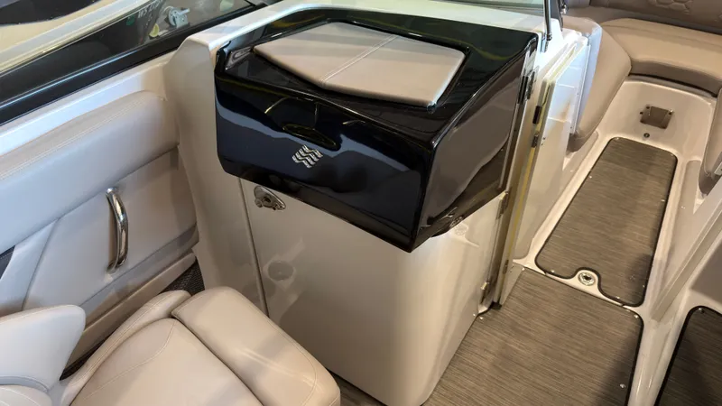 Slide: The Image of Interior of a 2022 Four Winns HD5 with sleek seating and a black cabinet. - 17