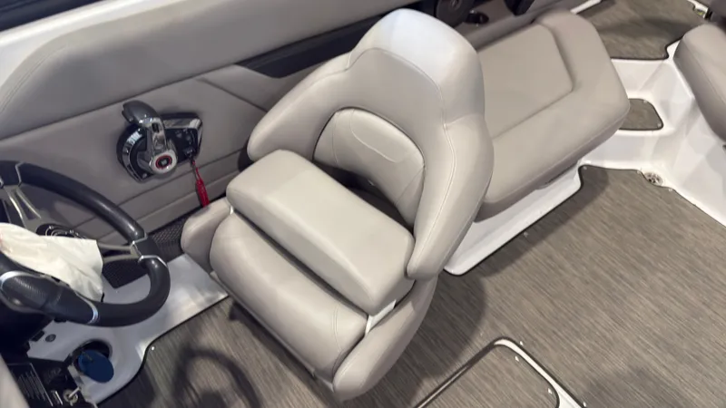Slide: The Image of The image shows the interior of a 2022 Four Winns HD5 with gray upholstery and a helm station. - 20