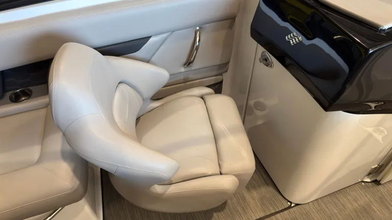 Slide: The Image of A luxurious, swiveling captain's chair in white leather within a modern boat cockpit. - 15