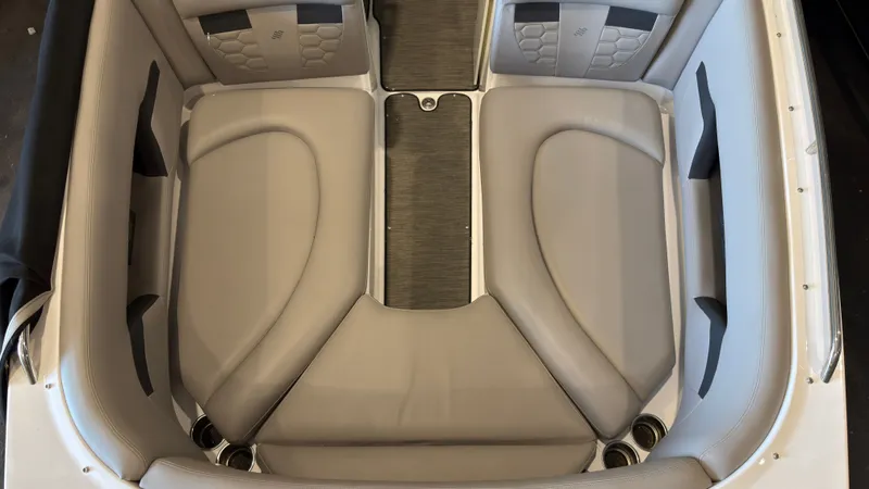 Slide: The Image of The image shows the interior of a 2022 Four Winns HD5 boat with gray upholstery. - 38