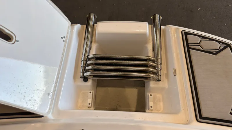Slide: The Image of A folded swim ladder on a boat, surrounded by white and gray surfaces. - 36
