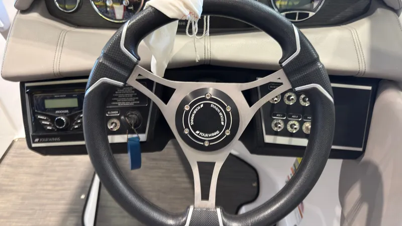 Slide: The Image of The image shows the steering wheel of a 2022 Four Winns HD5 boat with modern controls. - 22