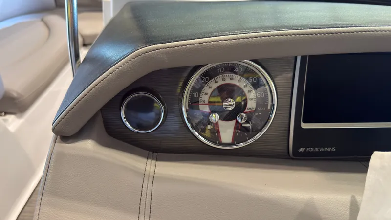Slide: The Image of Close-up of a Four Winns HD5 boat dashboard with speedometer and logo. - 24