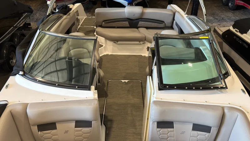 Slide: The Image of The image shows the interior of a 2022 Four Winns HD5 boat with beige seating. - 39