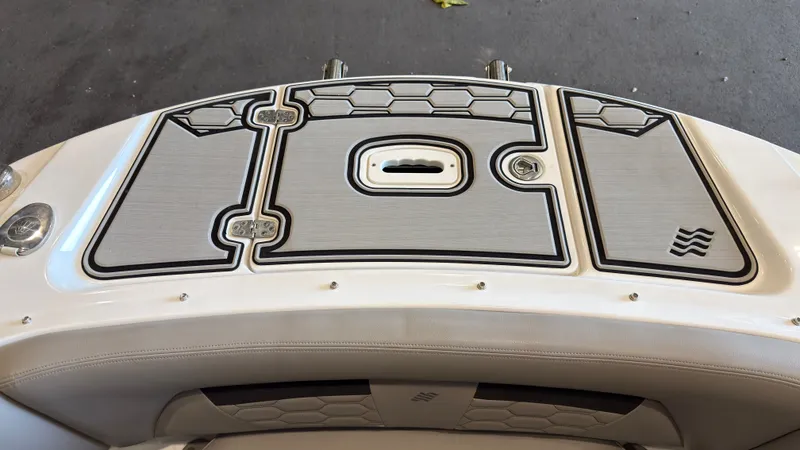 Slide: The Image of The image shows the stern of a 2022 Four Winns HD5 boat with textured deck surfaces. - 35
