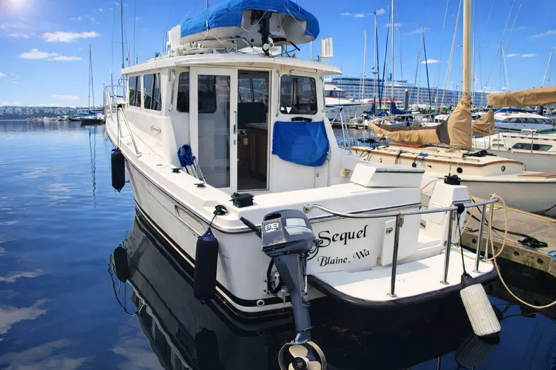Slide: The Image of 2005 Ocean Sport 30' boat docked in a marina under clear blue skies. - 6