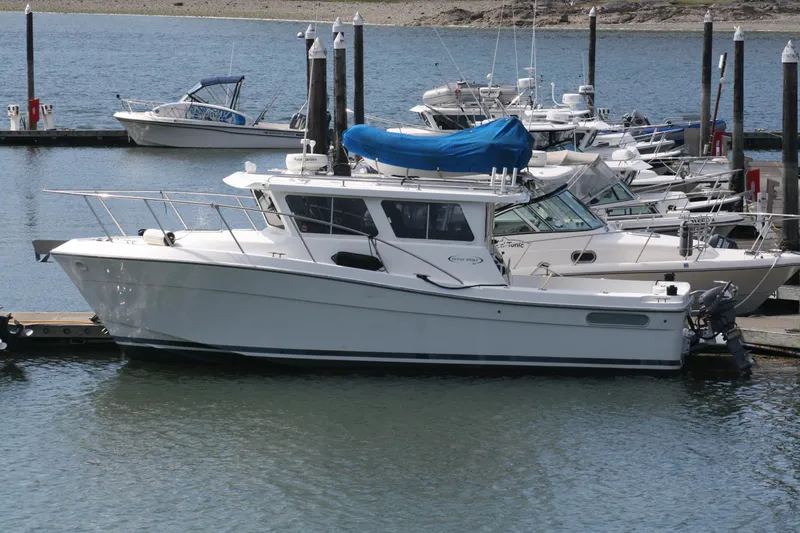 The Image of 2005 Ocean Sport 30' boat docked at marina with other vessels. - 0