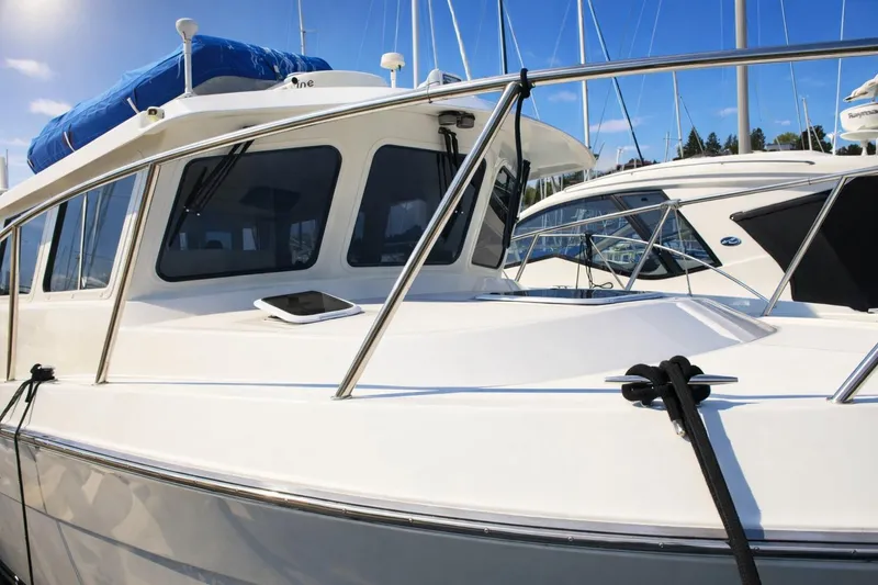 Slide: The Image of 2005 Ocean Sport 30' boat docked at marina under clear blue sky. - 5