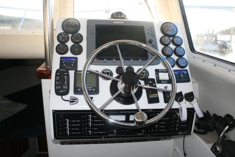 Slide: The Image of Control panel of a 2005 Ocean Sport 30' boat with steering wheel and gauges. - 8