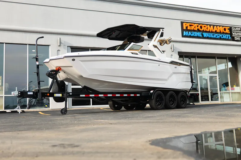 The Image of 2026 MasterCraft XStar 23 boat on trailer outside Performance Marine Watersports store. - 1