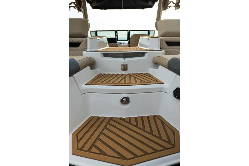 Slide: The Image of 2026 MasterCraft XStar 23 boat interior with teak-style flooring and cushioned seating. - 11