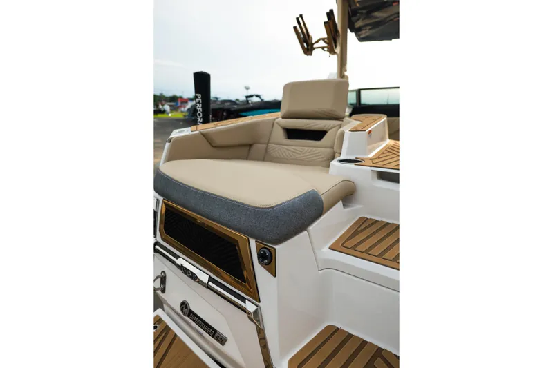 Slide: The Image of 2026 MasterCraft XStar 23 boat interior with beige seating and teak accents. - 12