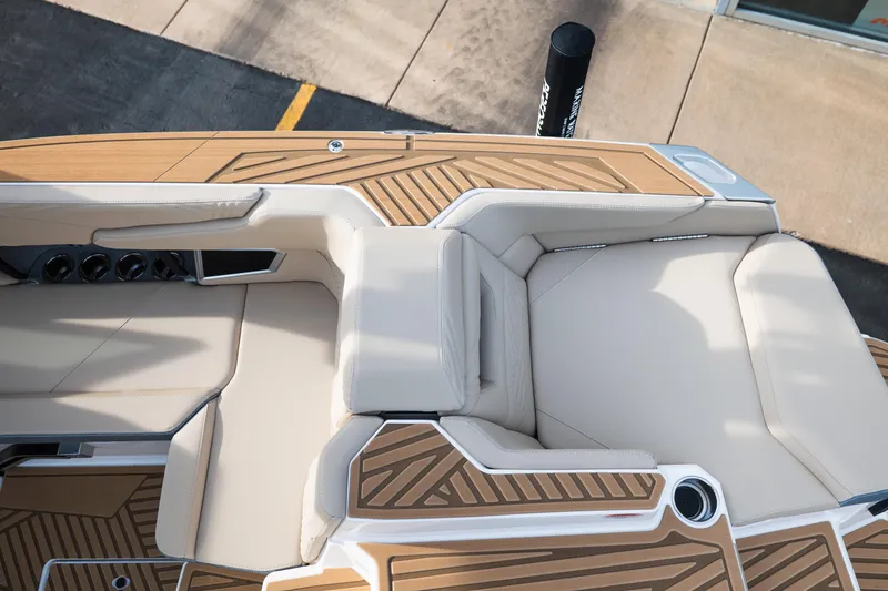 Slide: The Image of 2026 MasterCraft XStar 23 boat interior with beige seating and wood accents. - 15