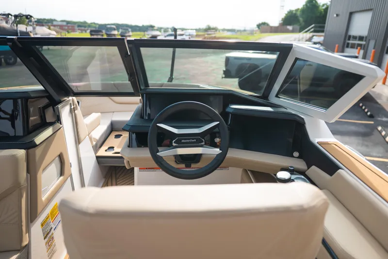 Slide: The Image of Interior view of 2026 MasterCraft XStar 23 boat cockpit with modern steering wheel. - 21