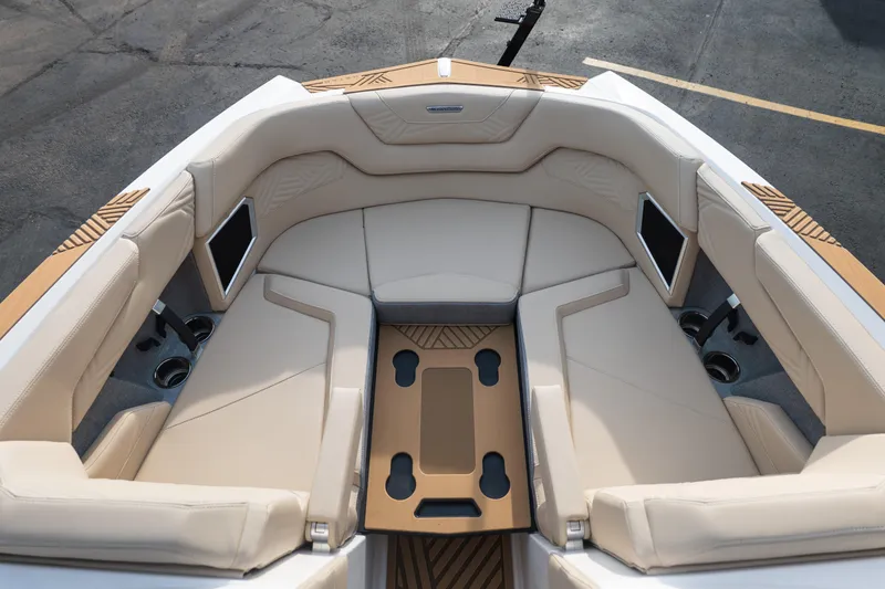 Slide: The Image of Luxurious interior of 2026 MasterCraft XStar 23 boat with beige seating and wood accents. - 23