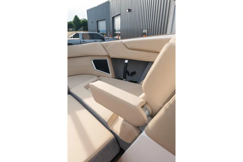 Slide: The Image of 2026 MasterCraft XStar 23 boat interior with beige seating and armrest. - 25