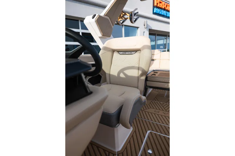 Slide: The Image of 2026 MasterCraft XStar 23 boat interior with luxurious beige seating and modern design. - 27