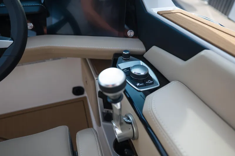 Slide: The Image of 2026 MasterCraft XStar 23 boat interior with modern control panel and luxurious beige seating. - 28