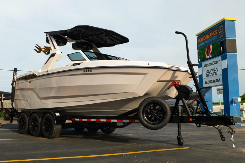 Slide: The Image of 2026 MasterCraft XStar 23 boat on trailer at Performance Marine Watersports dealership. - 41